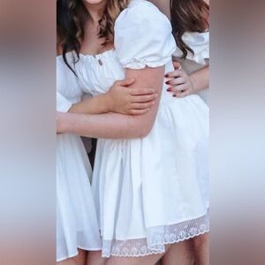 White mini dress, puffy sleeves with tight bodice and full skirt and lace detail